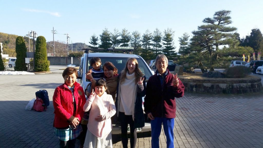 group of people in front of car