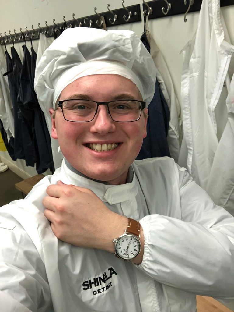 man in technical uniform showing off watch