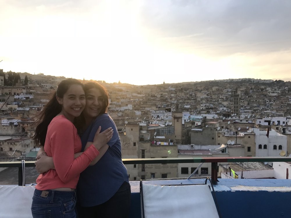 women hugging overlooking city