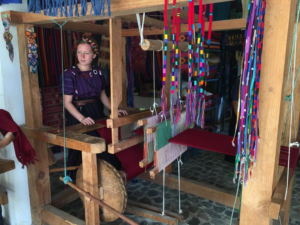 woman in traditional clothing at textile stand