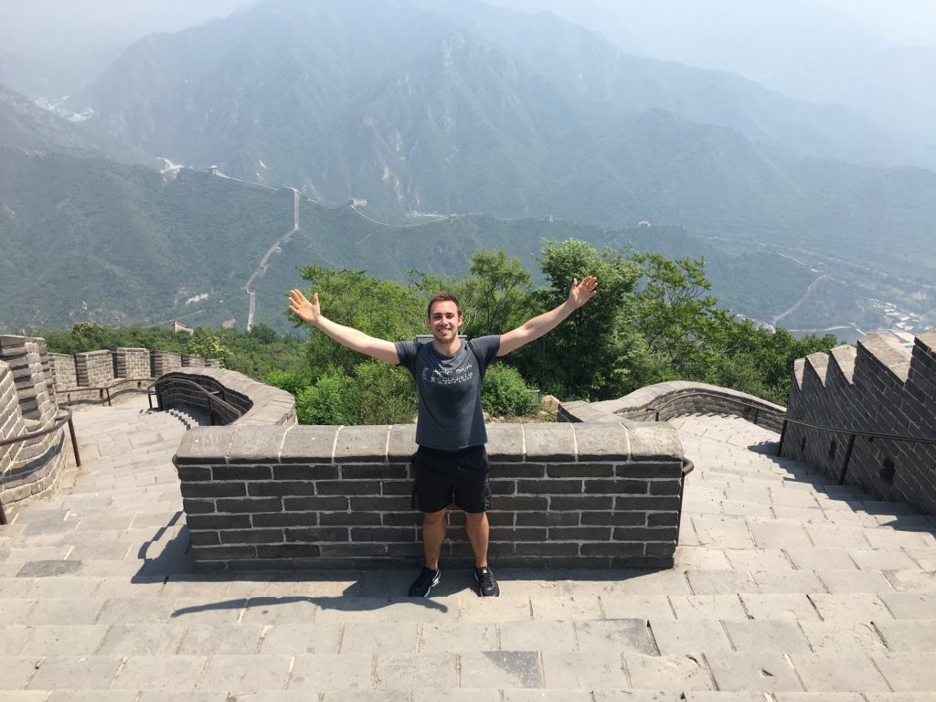 man with outstretched arms on great wall