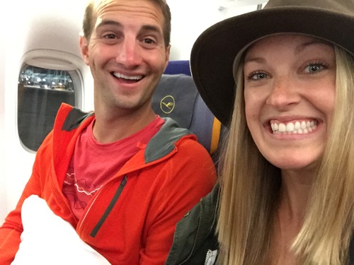 two people smiling on plane