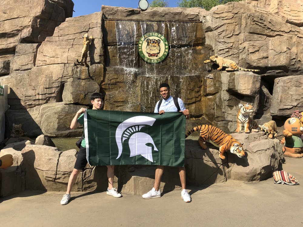 two people holding spartan flag
