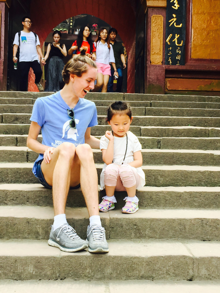 woman and child laughing together on steps