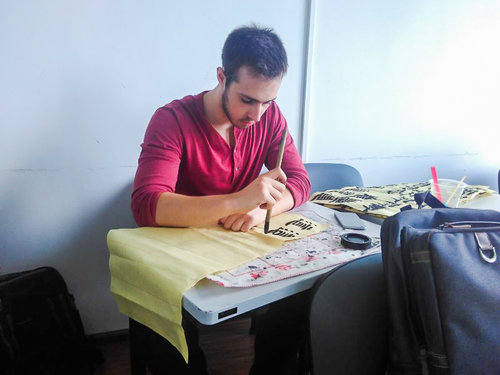man drawing Chinese characters with brush
