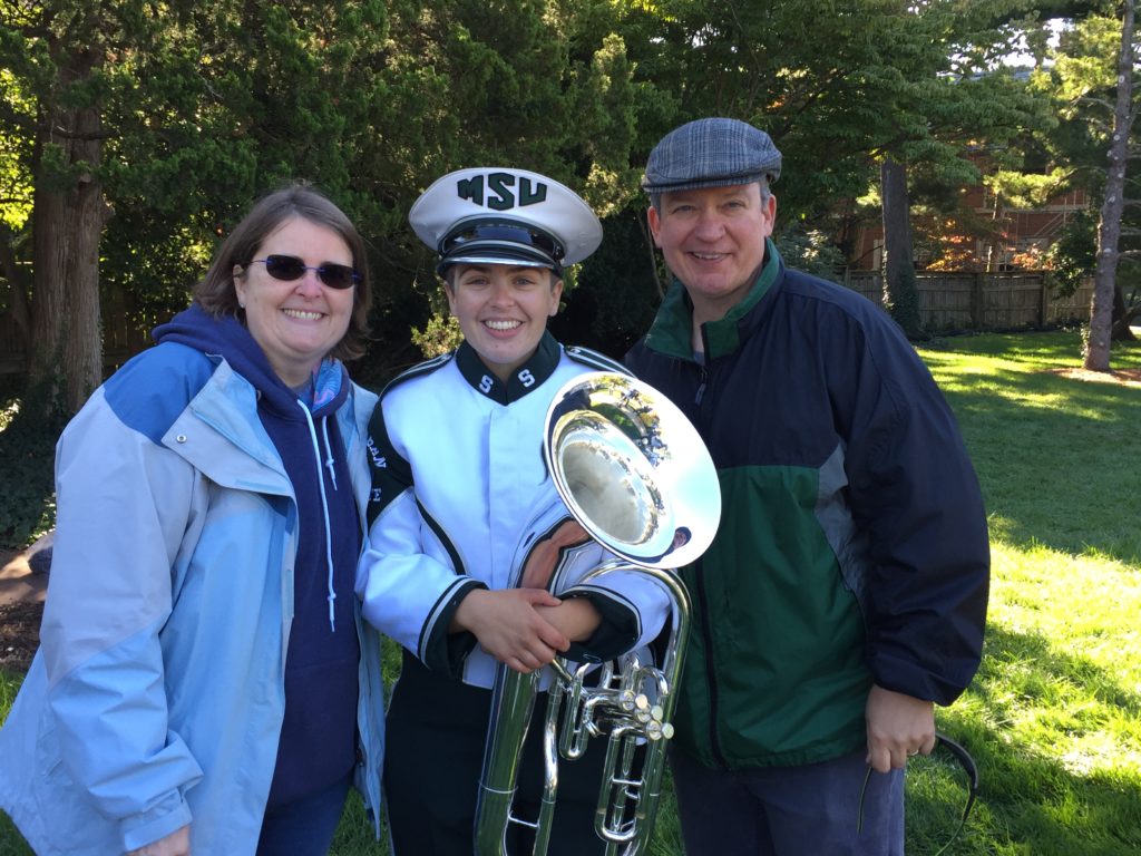 Kaylee in Marching band uniform with her parents